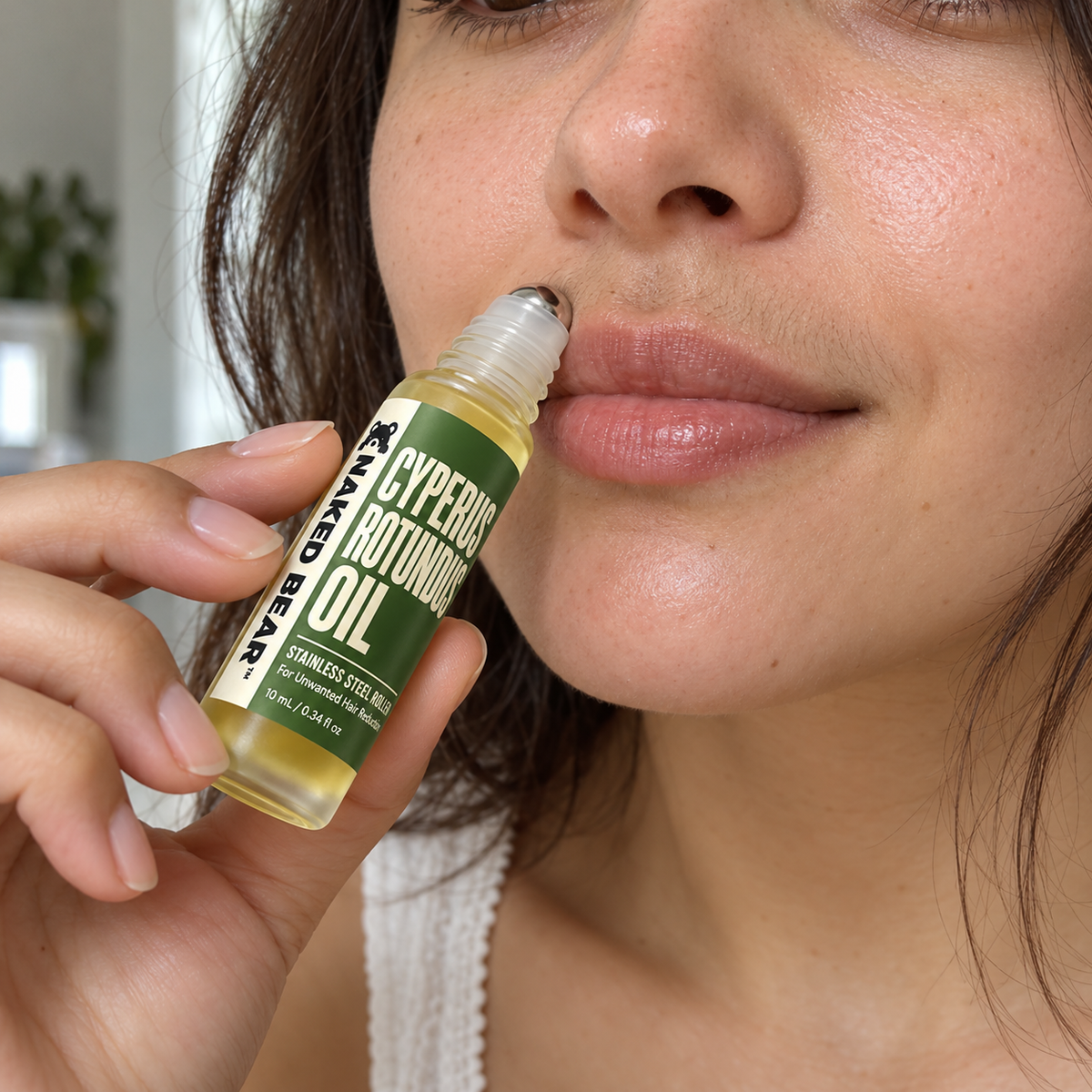 Woman applying Cyperus Rotundus Oil with a roller